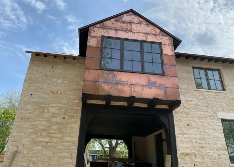 Copper metal panel facade on a stone building for Skylight Installation in San Marcos
